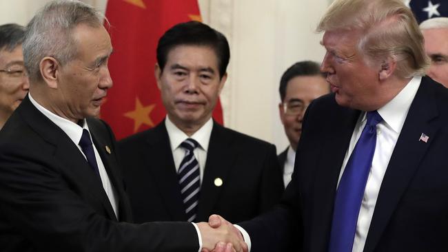 President Donald Trump shakes hands with Chinese Vice Premier Liu He, after signing the trade agreement in the East Room of the White House.