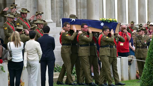 One of the three unknown soldiers coffins is carried in to the British cemetery near Pozieres France today. The three were buried with full military honours. Picture: David Bailey.