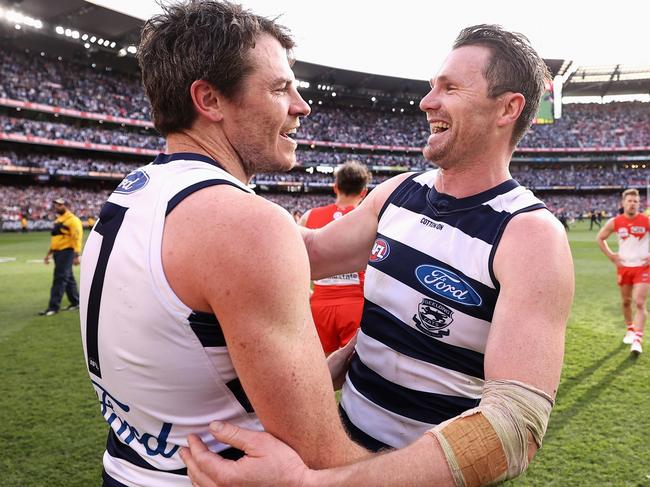 MELBOURNE, AUSTRALIA - SEPTEMBER 24: Isaac Smith of the Cats and Patrick Dangerfield of the Cats celebrate winning the 2022 AFL Grand Final match between the Geelong Cats and the Sydney Swans at the Melbourne Cricket Ground on September 24, 2022 in Melbourne, Australia. (Photo by Cameron Spencer/AFL Photos/via Getty Images)