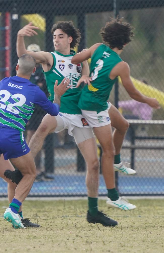 Chris Bourne (left) and Konner Allcott go at it for Gembrook Cockatoo.