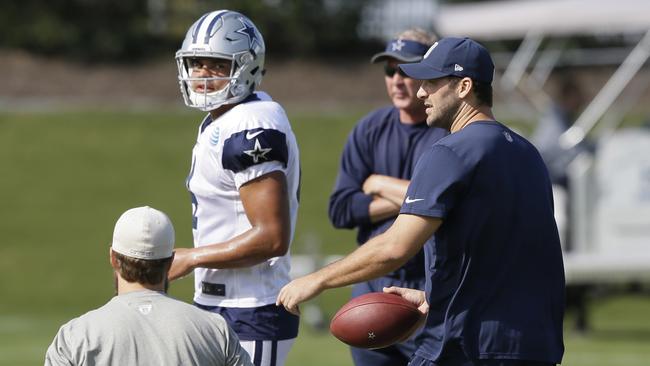 Dallas Cowboys quarterback Tony Romo, right, runs a drill with fellow quarterback Dak Prescott.