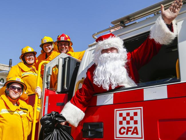 Keysborough CFA santa. Keysborough CFA volunteers posing fwith Santa and the tanker to promote their Christmas Eve run around the local community. Firefighters Gillian Grigg, Sylvia Coombe, Sarah Croft, captain Paul Townsend and Santa. Picture: Valeriu  Campan