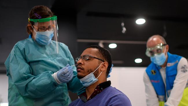 A medical worker of the Medical Emergency Services of Madrid (SUMMA 112) takes a swab sample from a man in Madrid. Picture: AFP.