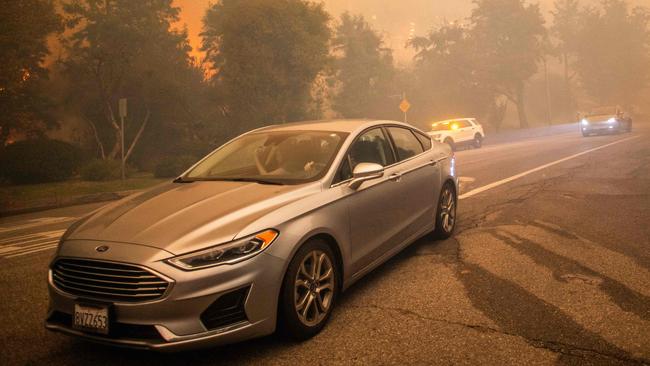 More than 30,000 people have been told to evacuate, with some abandoning their luxury vehicles. Picture: Apu Gomes / GETTY IMAGES NORTH AMERICA / Getty Images via AFP