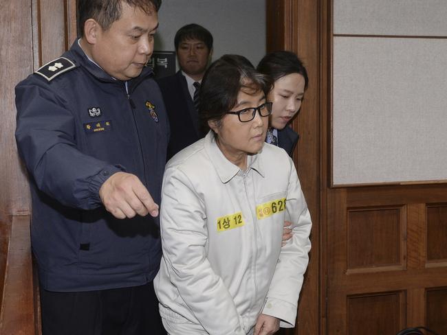Choi Soon-sil, center, the jailed confidante of disgraced South Korean President Park Geun-hye, appears for the first day of her trial at the Seoul Central District Court in Seoul, South Korea. Picture: AP