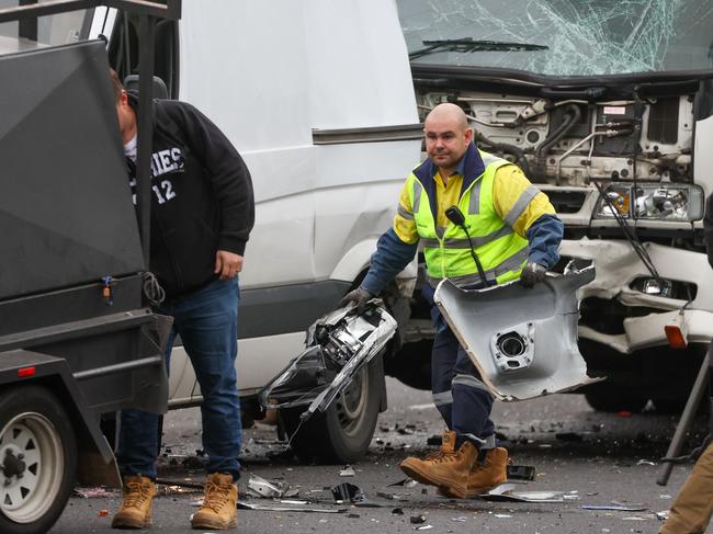 MELBOURNE, AUSTRALIA- JUNE 15 2022, A man cleans up at a Car crash on the Monash near Yarra Bvld involving 3 cars and a truck.Picture: Brendan Beckett