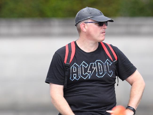 An AC/DC fan shows his colours outside the funeral. Picture: AAP Image/Dean Lewins