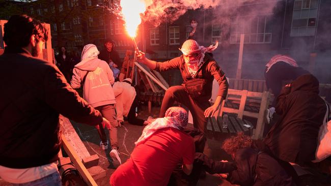 Clashes erupt as masked men with flares attack the Gaza protest camp on Amsterdam University campus. Picture: Getty Images