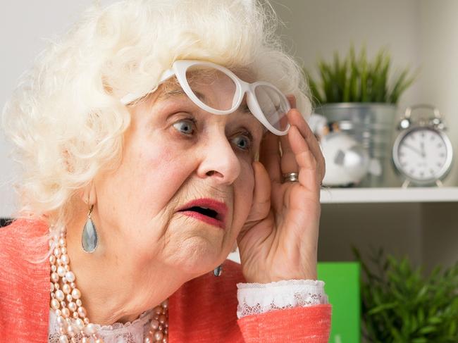 TRISH - NEWS.COM.AU COMMENT STORY -  Grandma working at the office and looking at the computer in disbelief lifting her glasses up  Picture: istock