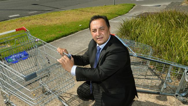 Cr Adem Atmaca inspects dumped trolleys.