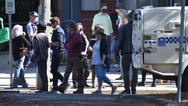 Police speak with people gathered outside Clarence Valley Council's temporary building during an anti-Covid laws protest. Picture: Jenna Thompson