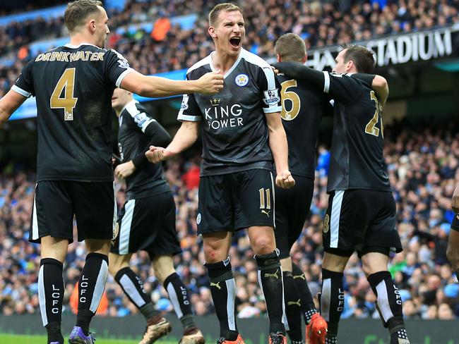 Leicester City's Marc Albrighton, centre, celebrates after Robert Huth scores his side's third goal.