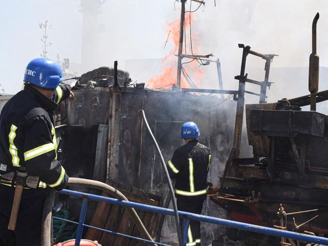 Ukrainian firefighters battling a fire on a boat burning in the port of Odessa after missiles hit the port. Picture: Odessa City Council Telegram channel/AFP