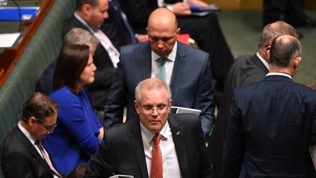 Prime Minister Scott Morrison and Minister for Home Affairs Peter Dutton leave after Question Time in the House of Representatives on Thursday. Picture: AAP