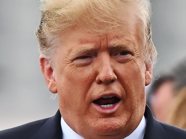 US President Donald Trump talks with Japan's Prime Minister Shinzo Abe as he leaves the Japan's navy ship Kaga in Yokosuka on May 28, 2019. (Photo by Charly TRIBALLEAU / POOL / AFP)