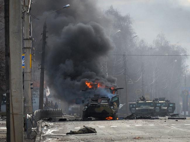 A Russian armoured personnel carrier burns near an unidentified soldier's body during a fight with the Ukrainian armed forces in Kharkiv at the weekend. Picture: AFP