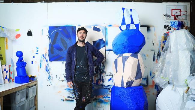 Elliott Routledge in his studio in Annandale with some his work. Picture: John Feder