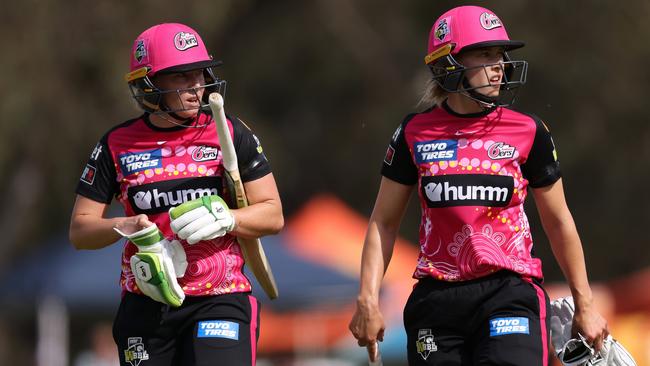 Alyssa Healy and Maitlan Brown of Sydney Sixers walk from the field at the end of the innings. Picture: PAUL KANE/GETTY IMAGES