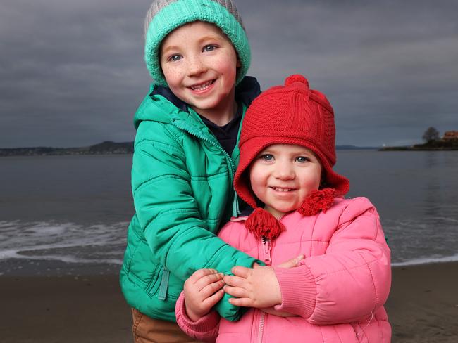 Siblings Elias, 5 and Rainier Tomlin, 2 of Mount Rumney are dressed in their puffy jackets as they enjoy the cold weather at Long Beach, Sandy Bay.  Picture: Zak Simmonds