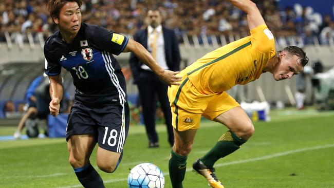 Japan's Takuma Asano gets away from Australia’s Brad Smith during their World Cup qualifier on Thursday night.