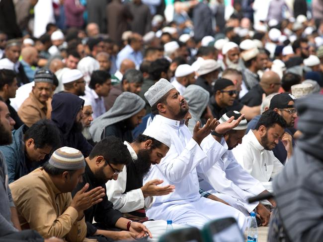 Muslims answer the call to pray at Hagley Park, opposite the Al Noor Mosque. Picture: AAP Image/SNPA, Martin Hunter