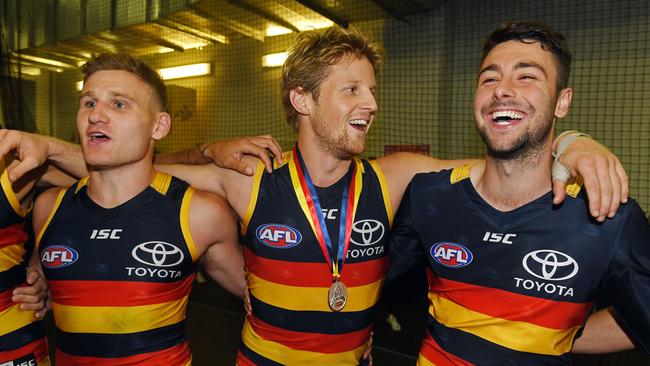 Crows players Rory Laird, Rory Sloane and Rory Atkins sing the song in the rooms after the team's win. Picture: Tom Huntley.