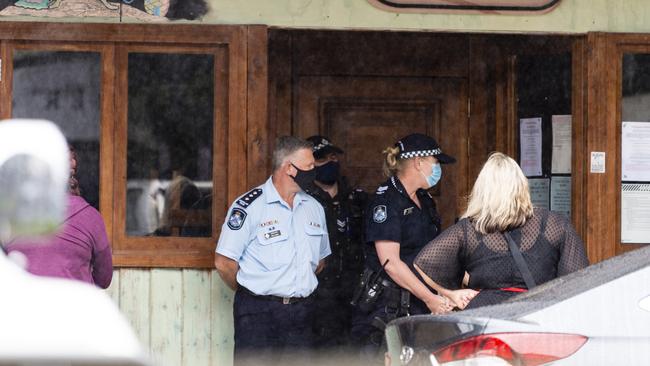 Police stand blocking the entrance to Bar Wunder as people gather on the footpath outside the Toowoomba bar shut down over failing to comply with public health orders, Friday, December 31, 2021. Picture: Kevin Farmer