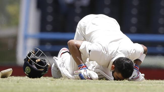 India's captain Virat Kohli kisses the ground after scoring a double-century against West Indies.