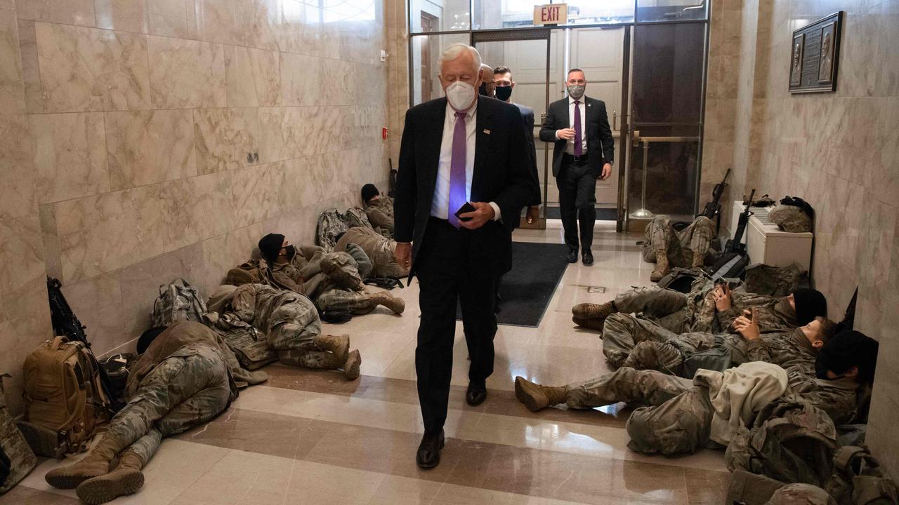 House Majority Leader Steny Hoyer, Democrat of Maryland, walks past resting members of the National Guard as he arrives at the US Capitol ahead of the House vote impeaching US President Donald Trump. Picture: AFP