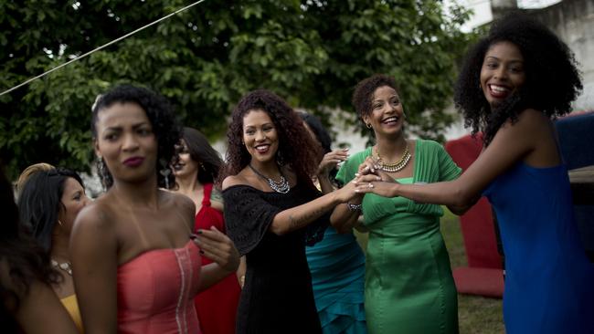 Female inmates in evening gowns take part in their jail's annual beauty contest. Picture: AP Photo/Silvia Izquierdo.