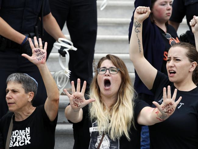 Activists chant as they are arrested by Capitol Hill Police officers as they protest the confirmation vote of Supreme Court nominee Brett Kavanaugh Saturday, Oct. 6, 2018 in Washington. Picture: AP Photo/Alex Brandon