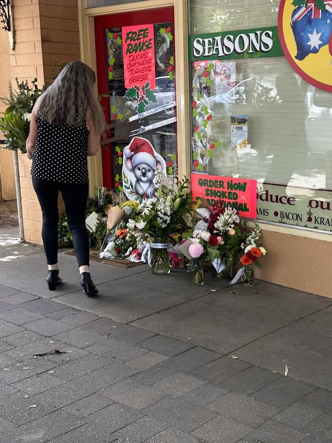 A woman leaves a floral tribute to Mr Noske. Picture: Supplied.