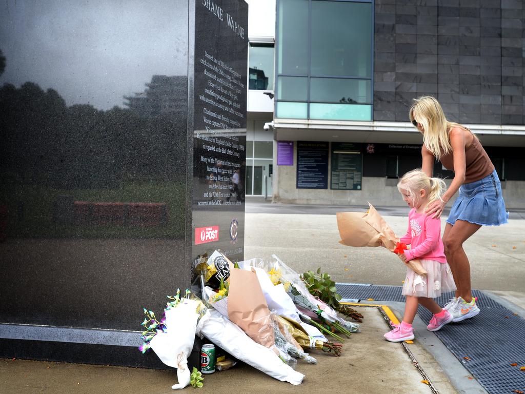 Even children, who were not born when Shane Warne played cricket, paid tribute at the statue. Picture: NCA NewsWire/Andrew Henshaw