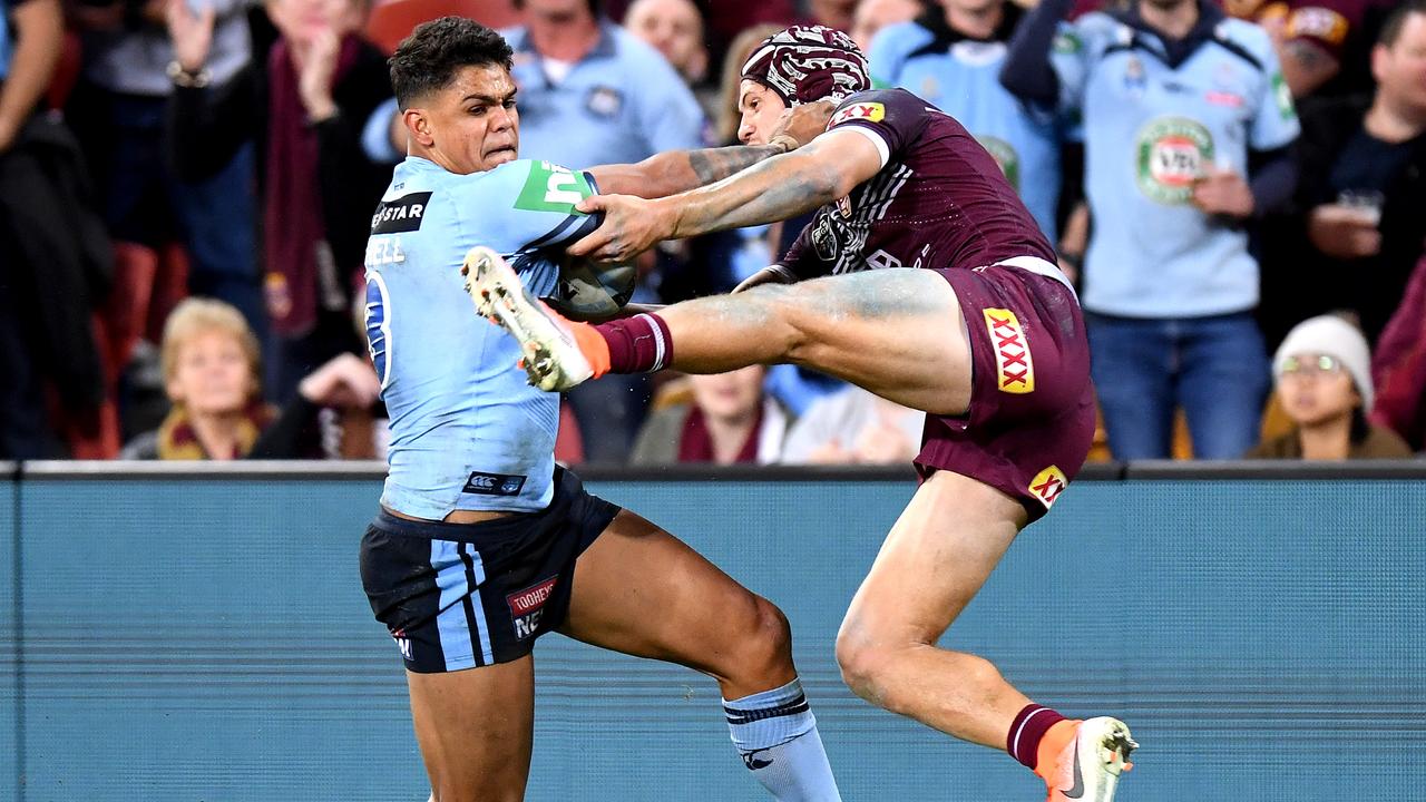 Kalyn Ponga tries to slow down a rampaging Latrell Mitchell in the final minutes of Origin I.