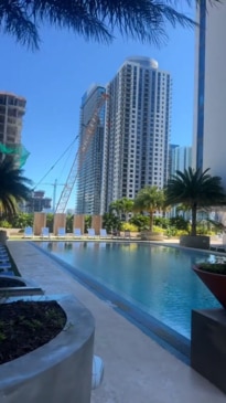 This resident is showing off the pool overlooked by a prison