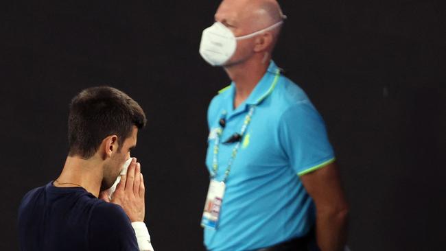 Novak Djokovic blows his nose at a practice session ahead of Alex Hawke’s decision to cancel his visa on Friday. Picture: AFP