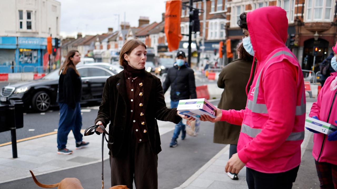 Volunteers hand out boxes of Covid-19 rapid antigen Lateral Flow Tests (LFT), in north east London on January 3. Picture: Tolga Akmen/AFP