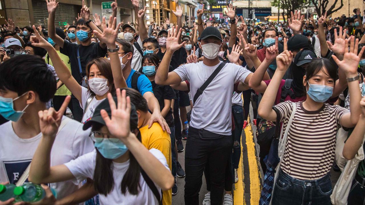 Protesters chant slogans with their hands up. Picture: Dale De La Rey/AFP