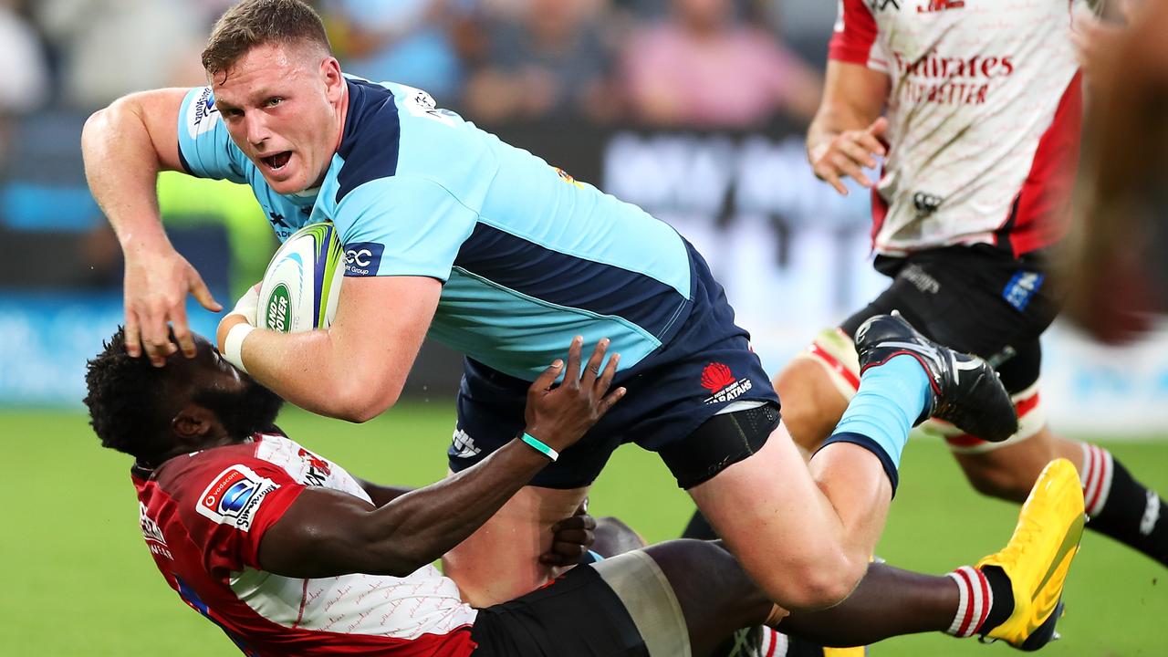 Angus Bell of the Waratahs is tackled during the round five Super Rugby match.
