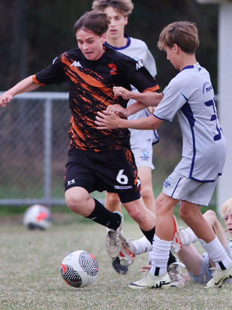 Premier Invitational Football 2024 tournament at Glennon Park Nerang. Field 2...Magic Utd (grey) V Football NT Utd. Picture Glenn Hampson