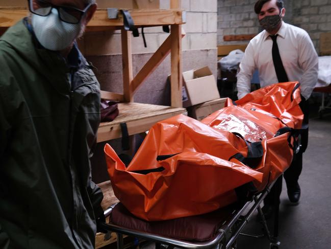 The body of a coronavirus victim is transported to a refrigerated container at a funeral home in Queens on April 29. Picture: AFP