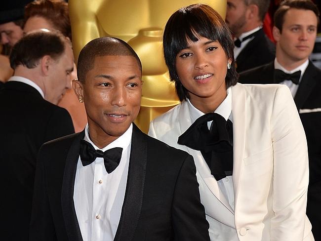 Happy ... Musician Pharrell Williams (L) and Helen Lasichanh attend the Oscars.