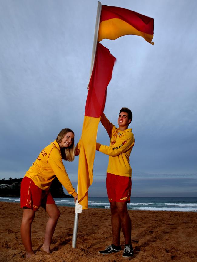 Mitch Ponton and Mia Roberts raise the flag. Picture: Martin Lange