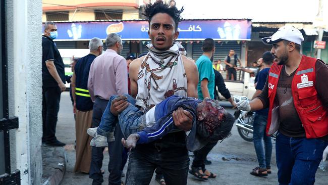 A badly wounded child is carried into a hospital following an Israeli strike in Rafah in the southern Gaza Strip. Picture: AFP