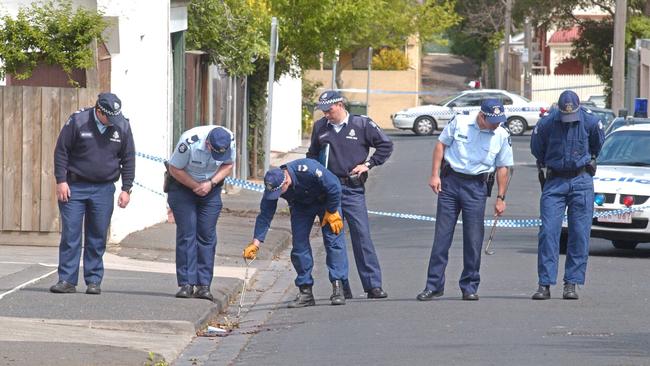 Police search Joy St after the murder of Michael Marshall.