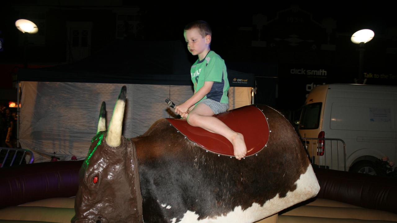 <p>Chris Paroz tries his luck on the mechanical bucking bull at the Mardi Gras. Photo Deanna Millard / Warwick Daily News</p>