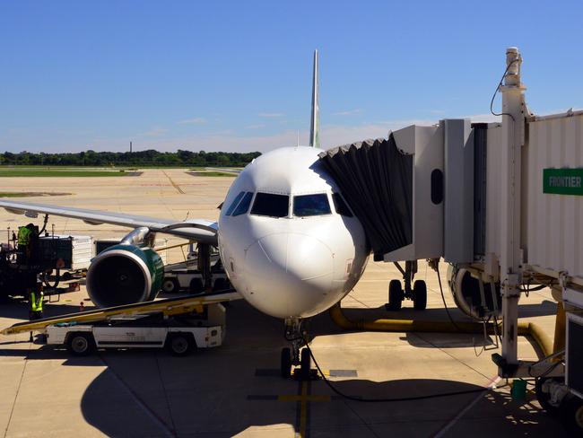 Denver, Colorado, USA: front view of a Frontier Airlines Airbus jet at passenger boarding bridge with aircon connection - ground services at work - Frontier Airlines is an American ultra low-cost carrier headquartered in Denver - Denver International Airport, Concourse A
