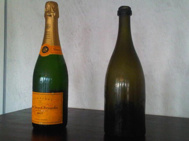 One of the salvaged bottles next to a modern bottle of Veuve Clicquot. Picture: AP Photo/Lehtikuva/Jussi Nukari