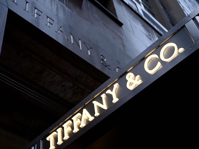 (FILES) In this file photo the logo of luxury jewelry and specialty retailer Tiffany & Co is seen on 5th Avenue in Manhattan on October 27, 2019  in New York City. - Shares of Tiffany were under pressure for a second straight session Wednesday following a report that its deal to be acquired by LVMH may be coming apart. Tiffany's stock was down 0.6 percent in mid-morning trading at $116.32 after shares dropped nine percent on June 3, 2020. Fashion publication Women's Wear Daily reported that the French luxury giant was reevaluating the $16.2 billion Tiffany acquisition previously seen as worthy investment to bolster the company's US presence. (Photo by Johannes EISELE / AFP)