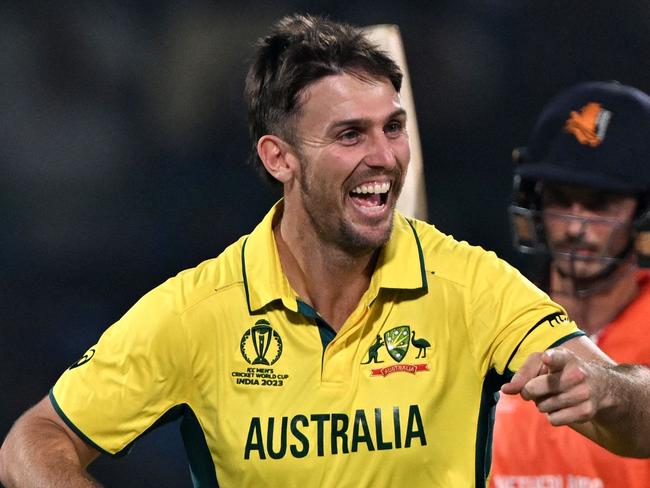 Australia's Mitchell Marsh (L) celebrates after taking the wicket of Netherlands' Sybrand Engelbrecht during the 2023 ICC Men's Cricket World Cup one-day international (ODI) match between Australia and Netherlands at the Arun Jaitley Stadium in New Delhi on October 25, 2023. (Photo by Arun SANKAR / AFP) / -- IMAGE RESTRICTED TO EDITORIAL USE - STRICTLY NO COMMERCIAL USE --